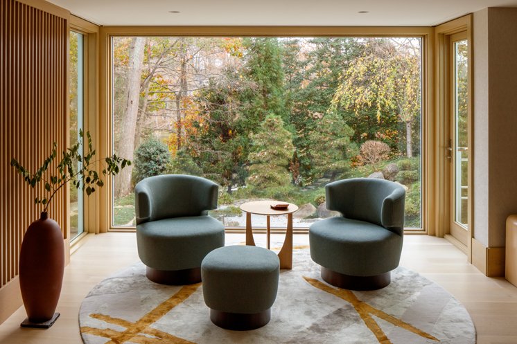 Modern Living room by large window looking at landscape